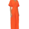 Model wearing a stylish modest midi dress with long sleeves and a high neckline in a subtle floral pattern.