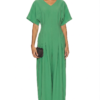 Model wearing a stylish modest midi dress with long sleeves and a high neckline in a subtle floral pattern. - green